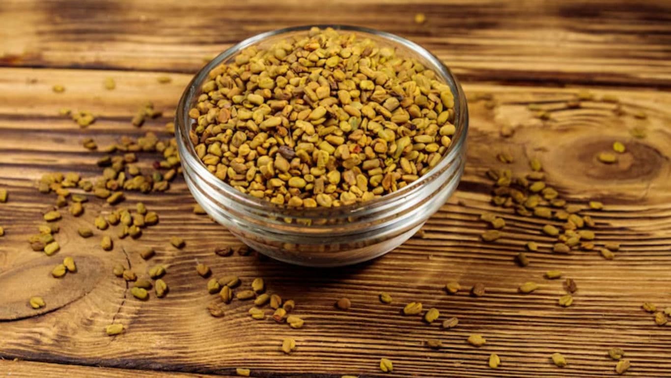 Glass Bowl of Fenugreek Seeds on Wooden Surface