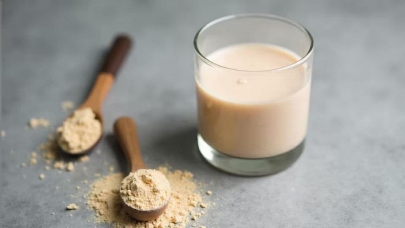 Glass of protein shake with powder