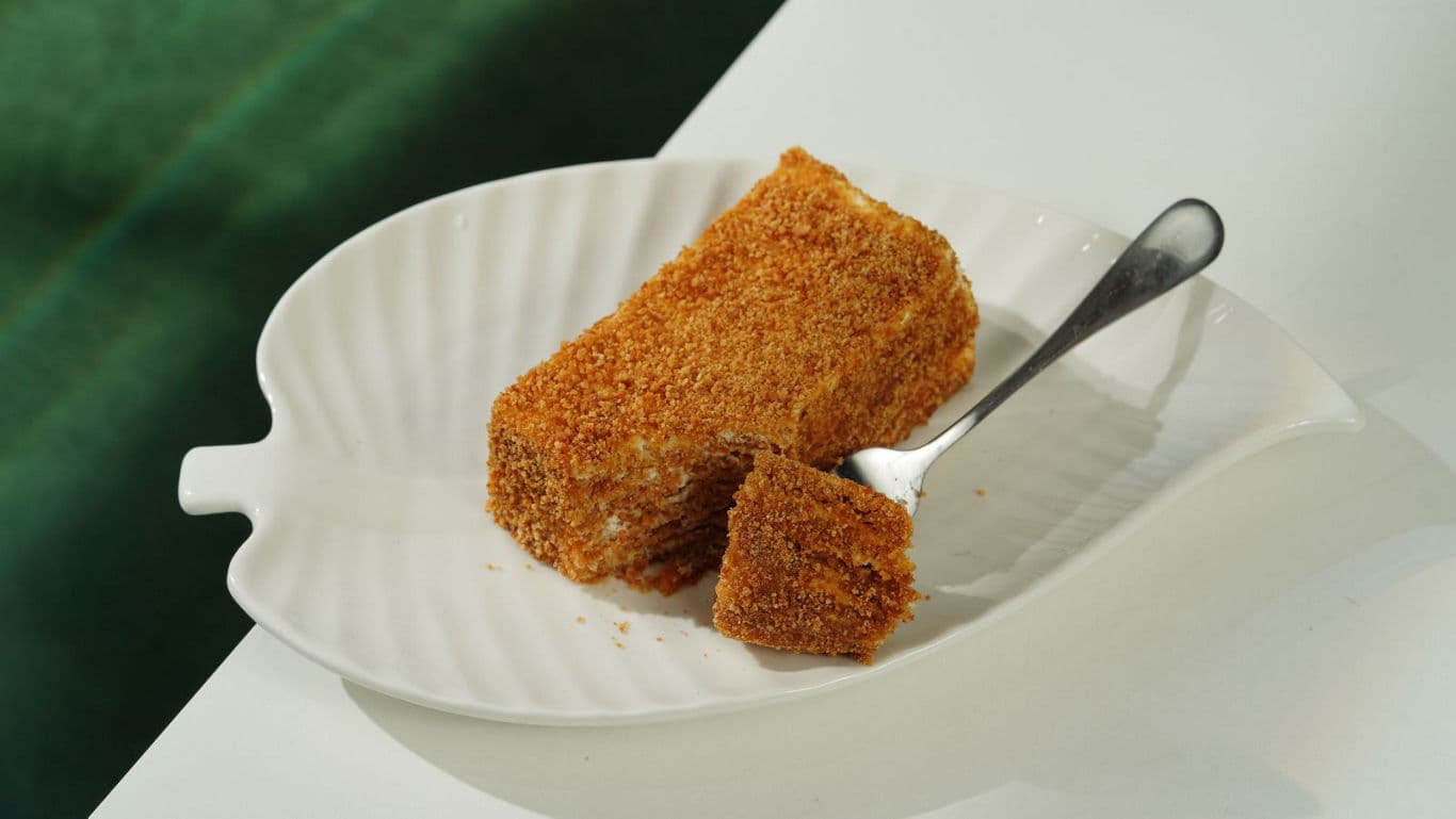 Slice of crumb-coated dessert on plate
