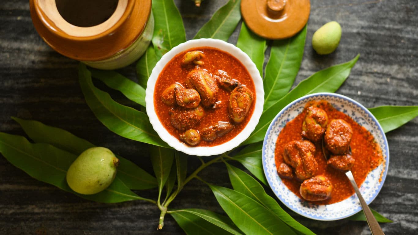 Traditional Mango Pickle in Ceramic Bowls with Leaves