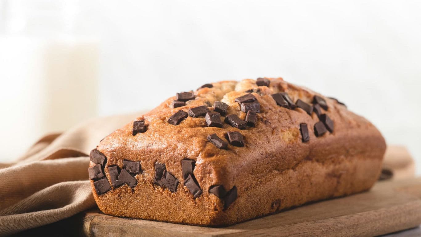 Chocolate chip loaf cake on wooden board