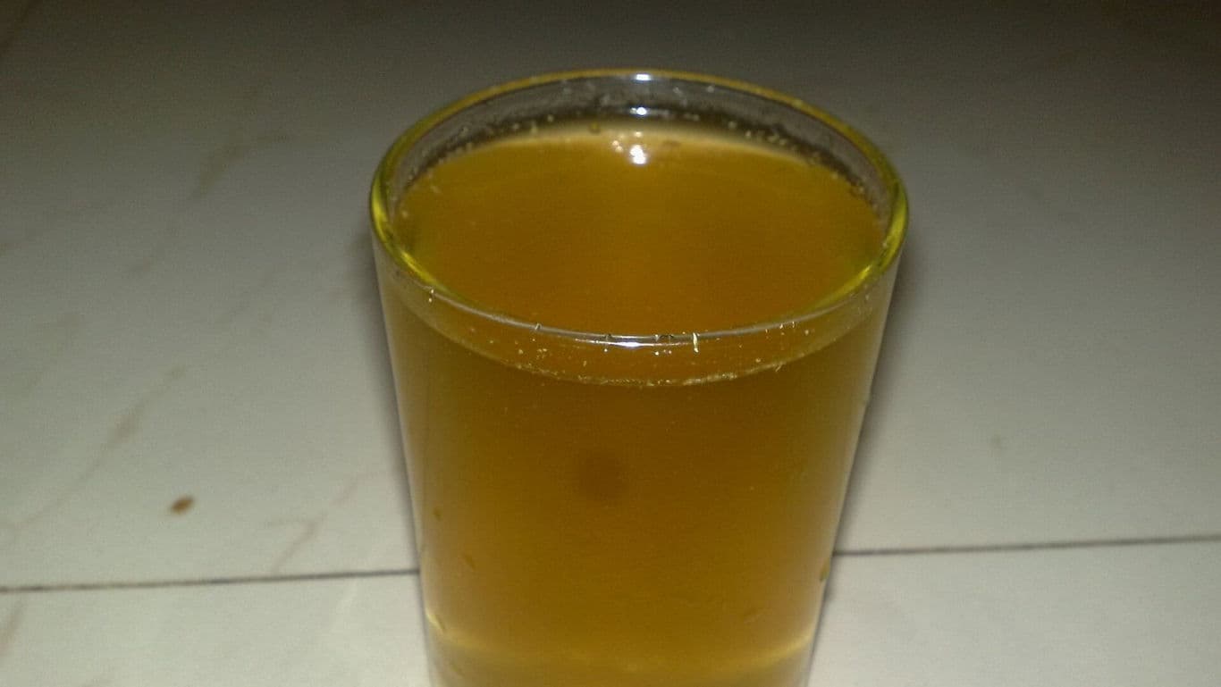 Clear Glass Filled With Light Brown Liquid