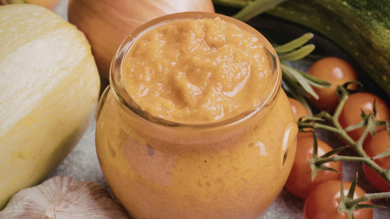 Jar of homemade vegetable puree with fresh ingredients