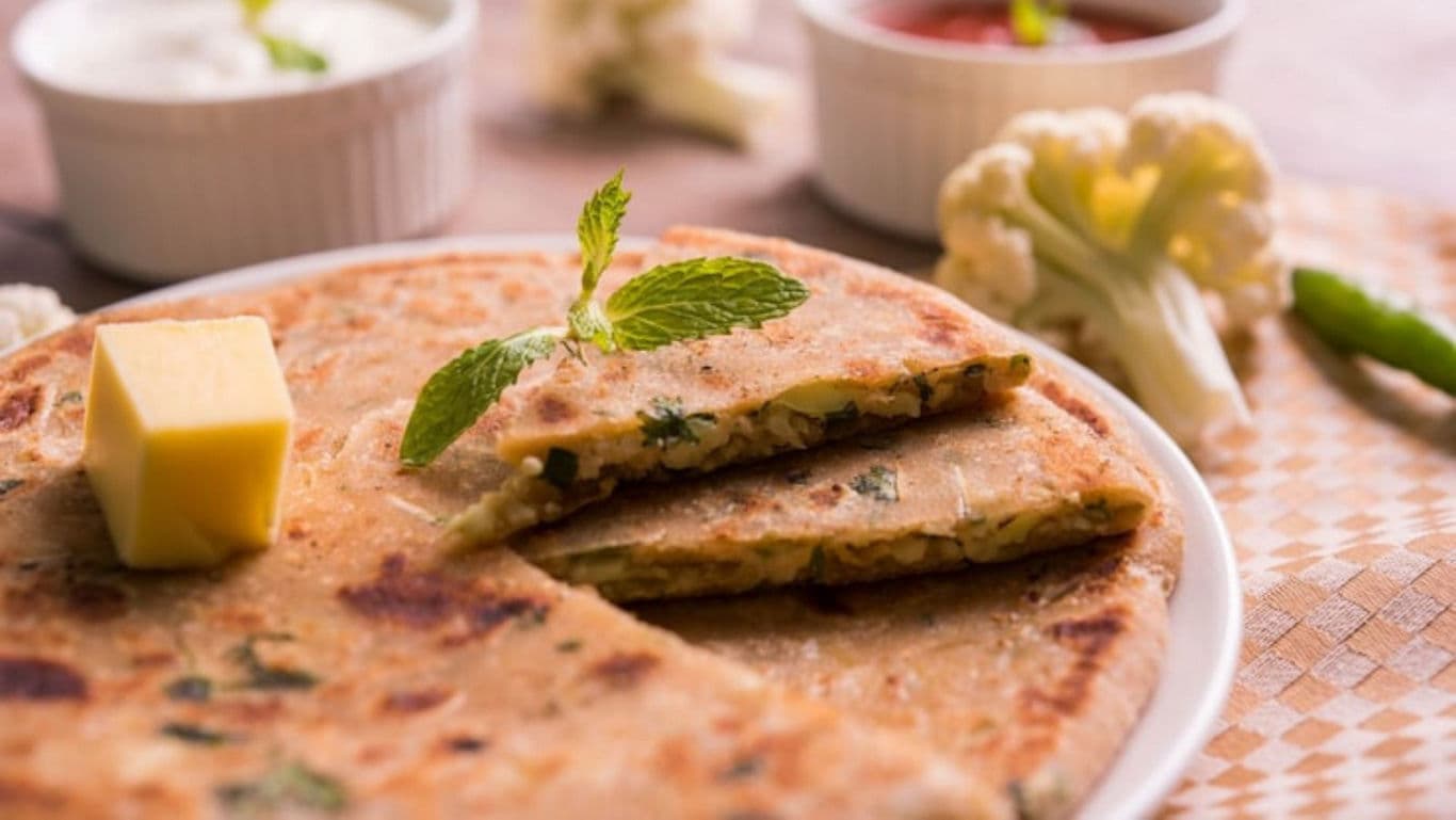 Stuffed paratha with butter and mint garnish