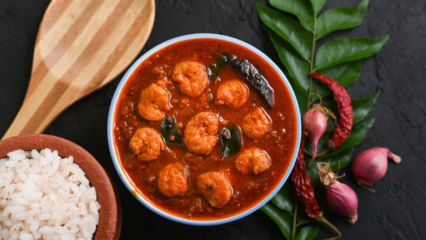 Spicy prawn curry with rice and herbs