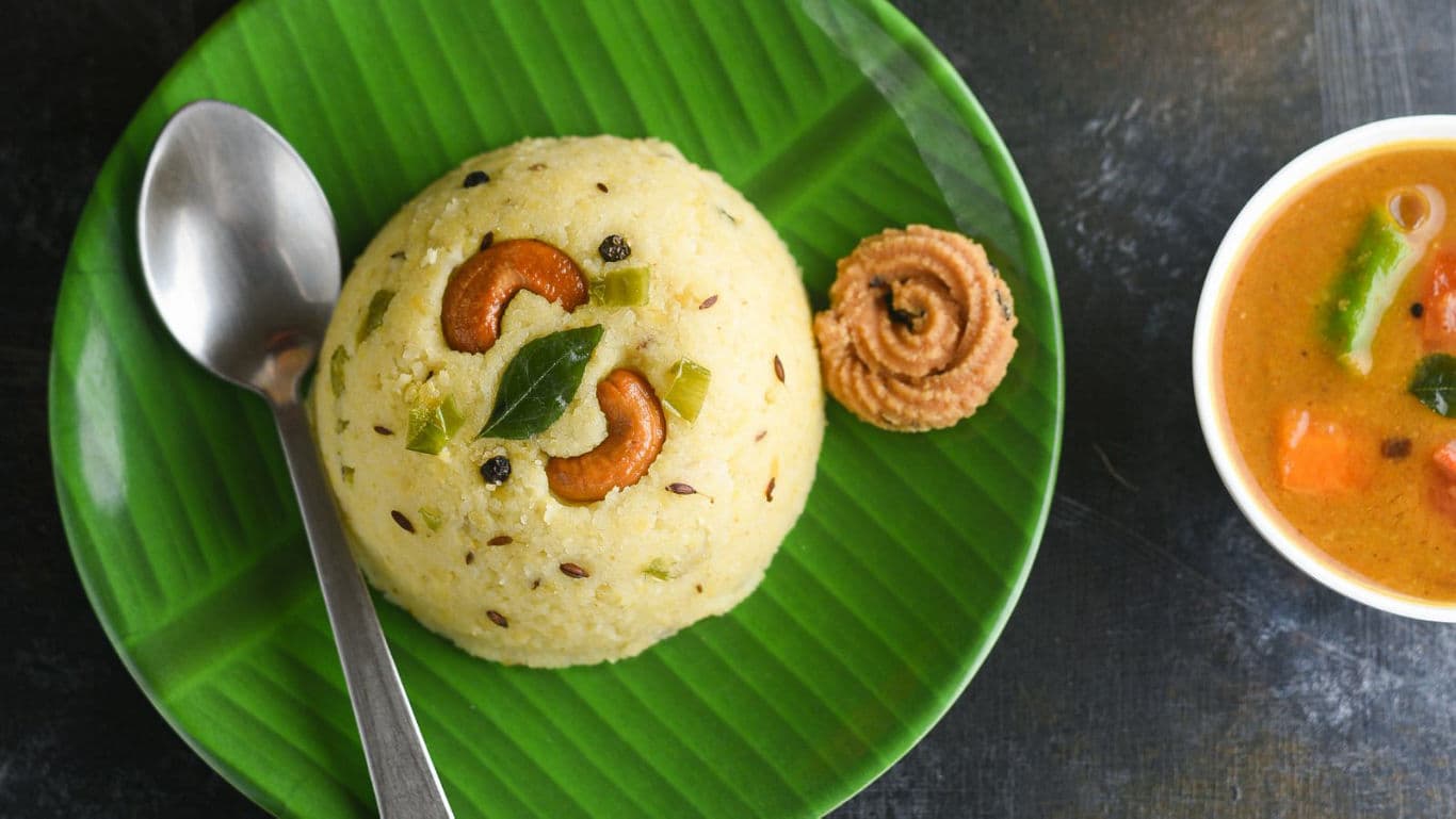 South Indian upma with cashews on banana leaf plate