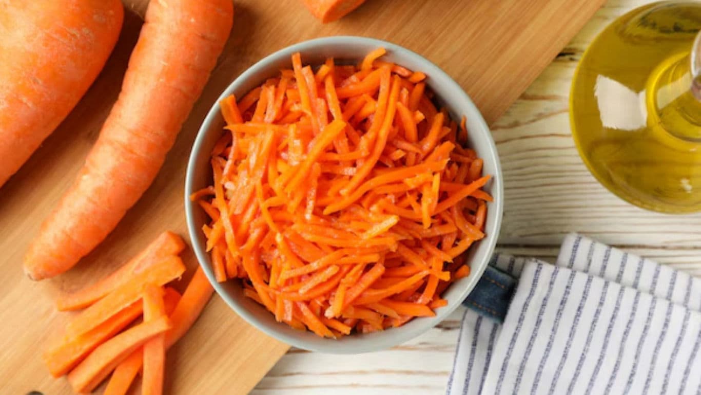 Shredded Carrots in Bowl with Fresh Ingredients