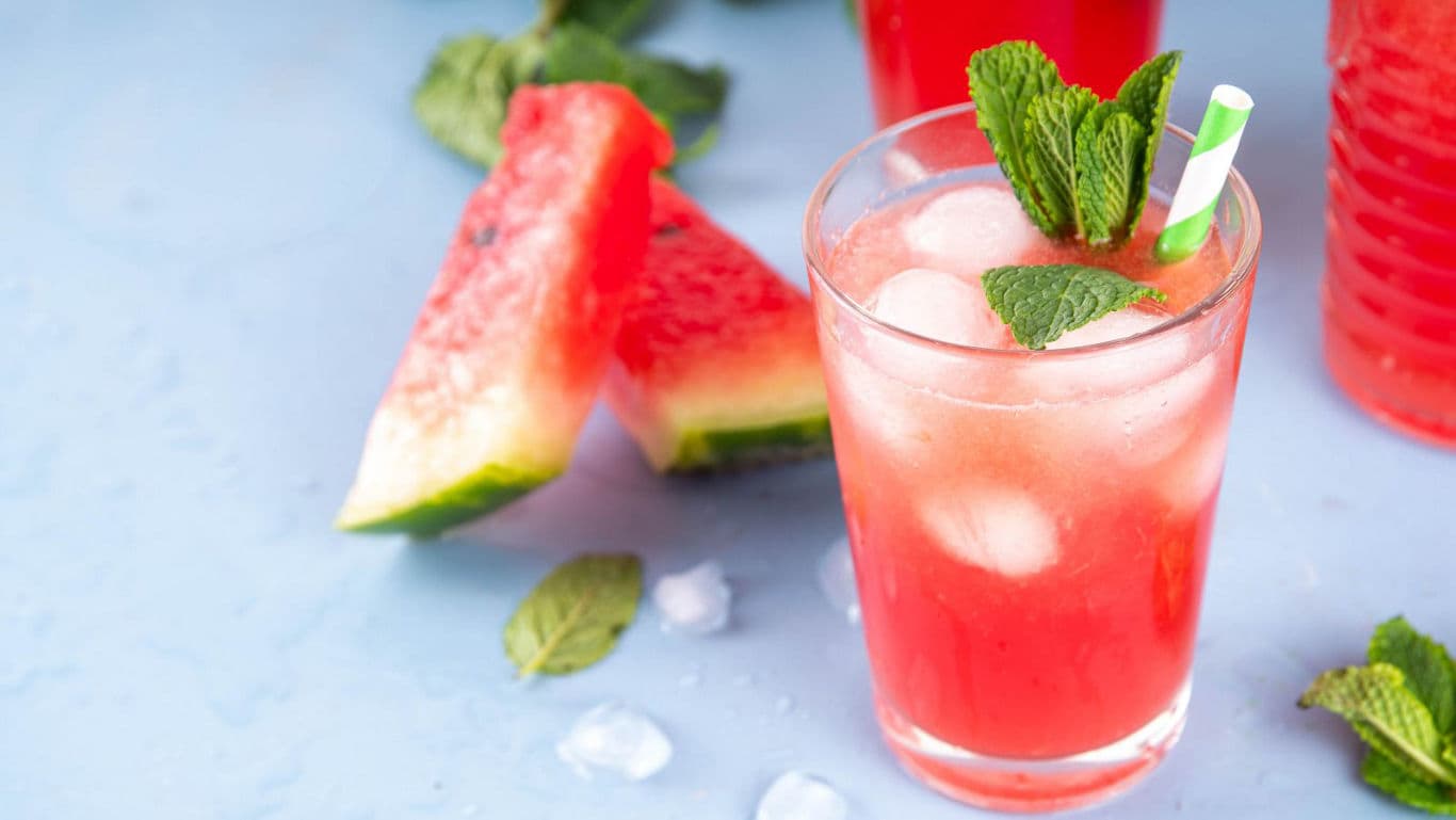 Refreshing watermelon drink with ice and mint garnish
