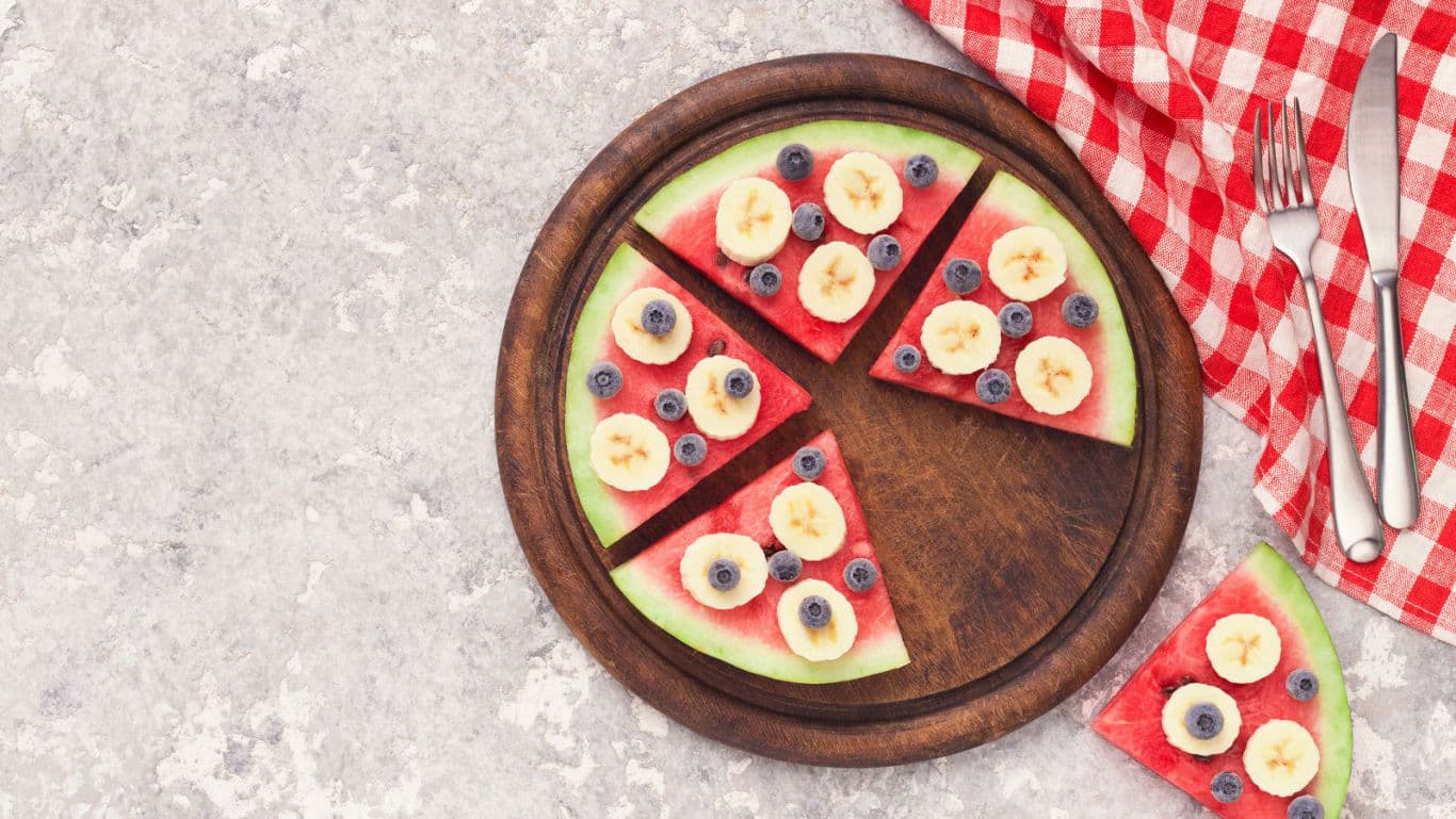 Watermelon fruit pizza slices with berries and banana