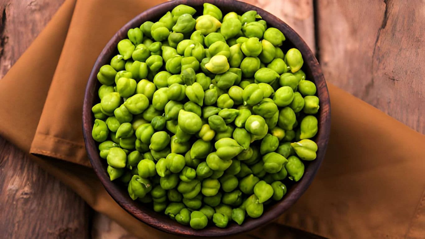 Fresh green chickpeas in wooden bowl