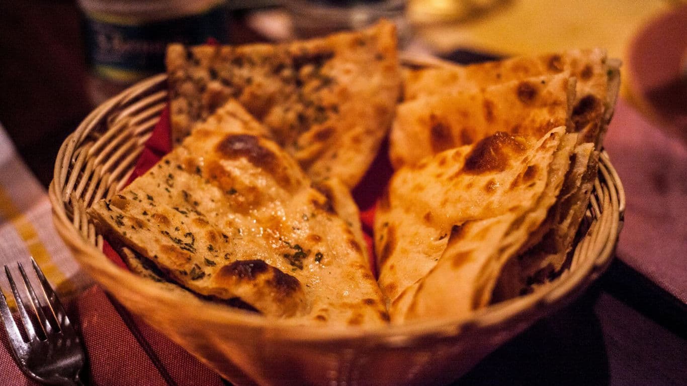 Basket of crispy flatbreads on table