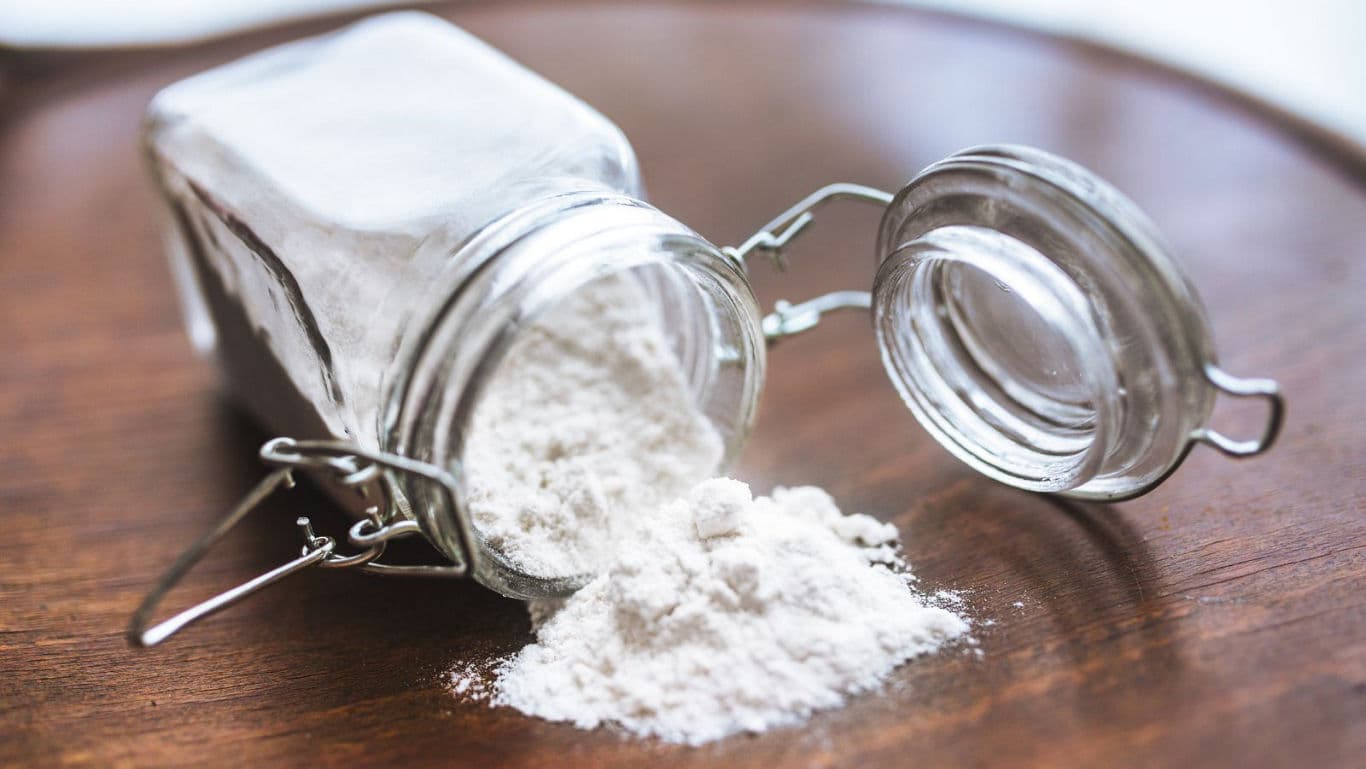 Glass jar with spilled white powder