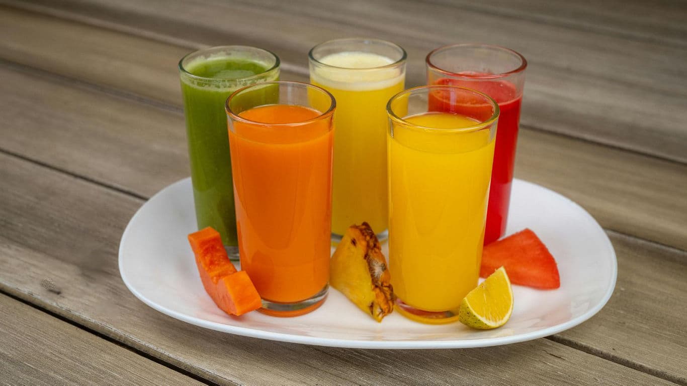 Colorful glasses of fresh fruit juices