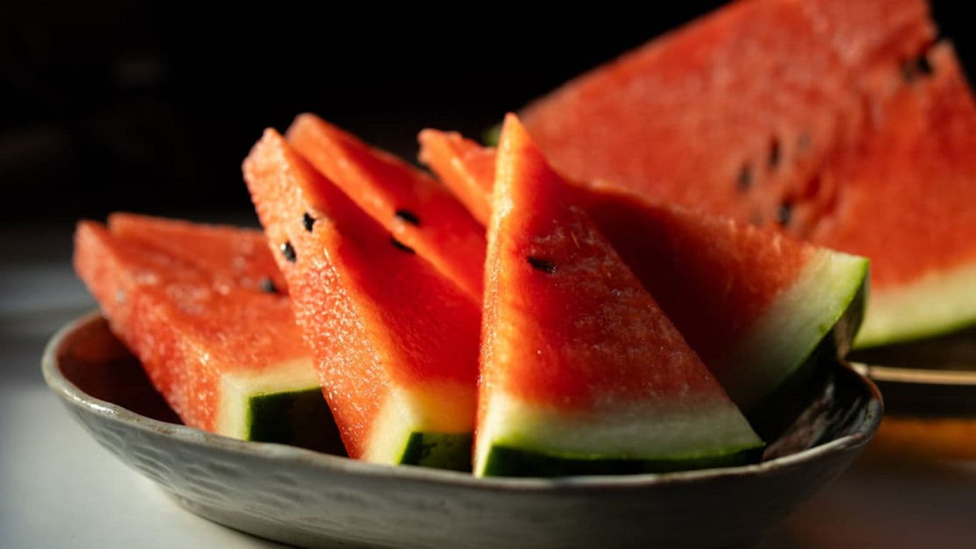 Fresh watermelon slices in ceramic bowl on table