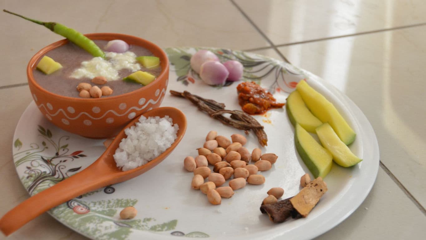 Traditional Indian meal with rice, peanuts, and condiments
