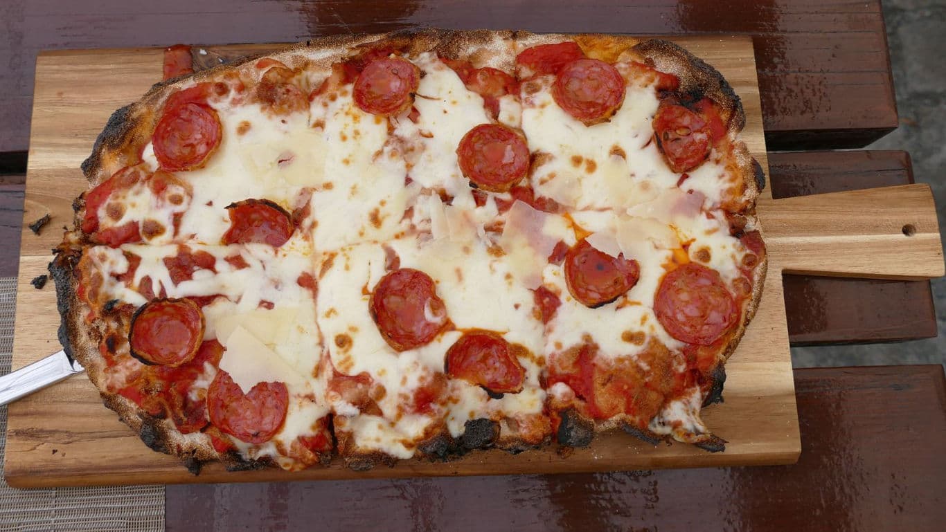 Freshly baked pepperoni pizza on board