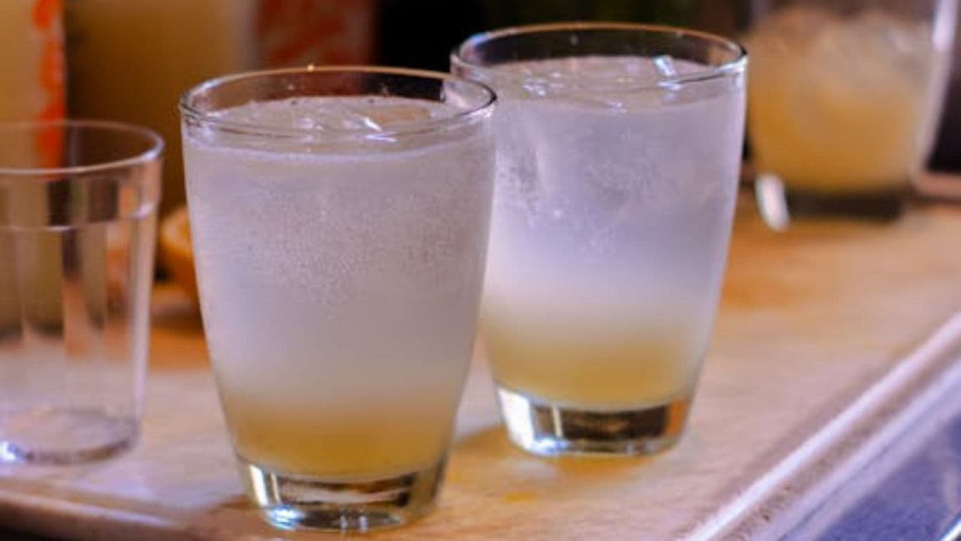 Two Chilled Citrus Cocktails on Wooden Surface