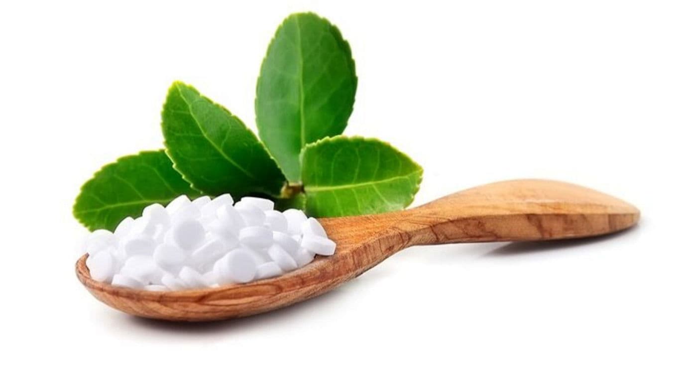 Wooden Spoon with White Sweetener and Green Leaves