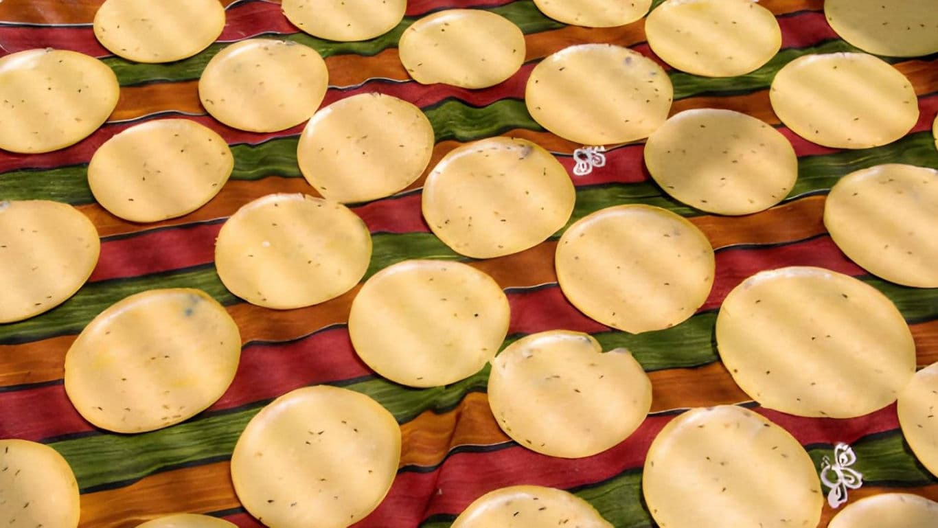 Round Papadums Drying on Colorful Striped Cloth