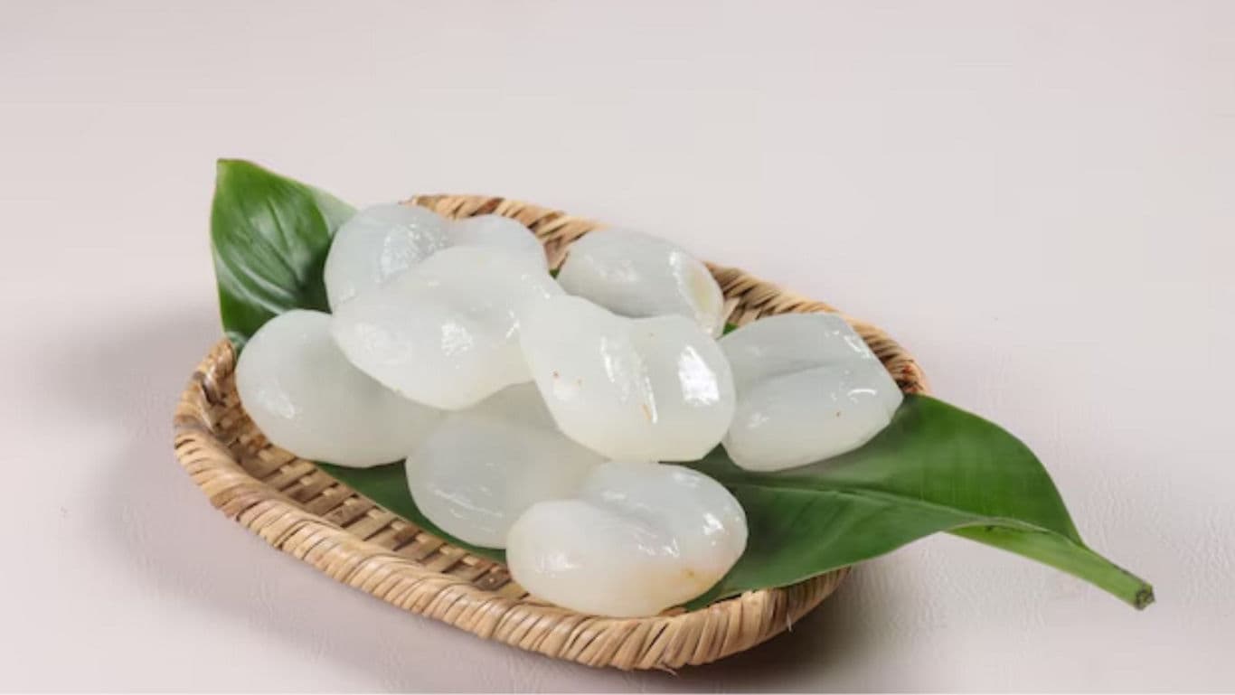 Fresh peeled palm fruit on green leaves in basket