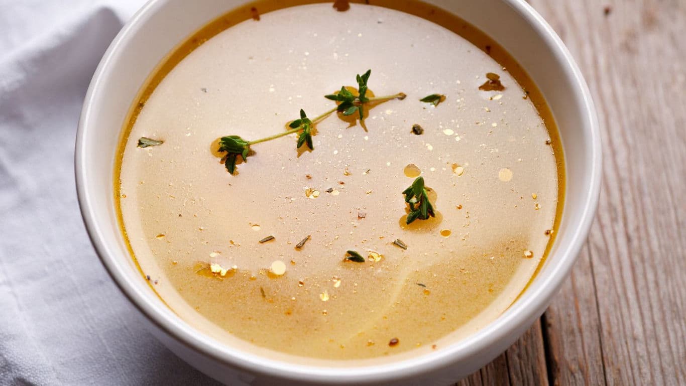 Warm clear broth with fresh herbs