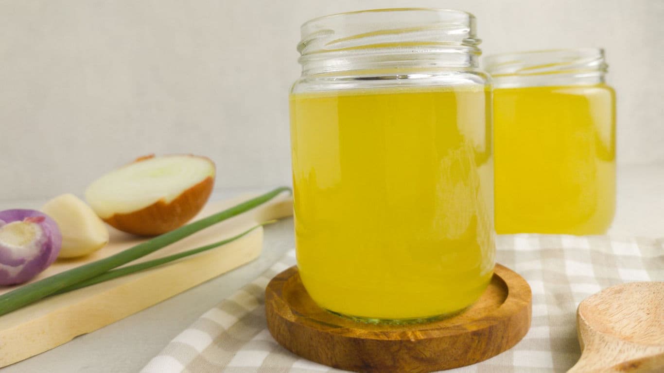 Glass jars of homemade yellow broth