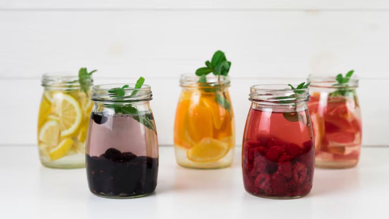 Assorted fruit infused water in glass jars