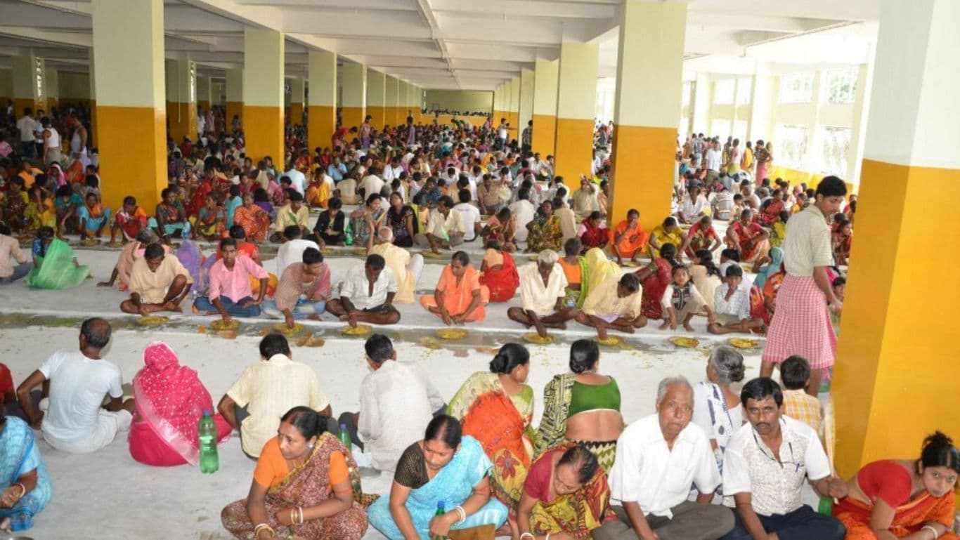 Large gathering seated for communal meal