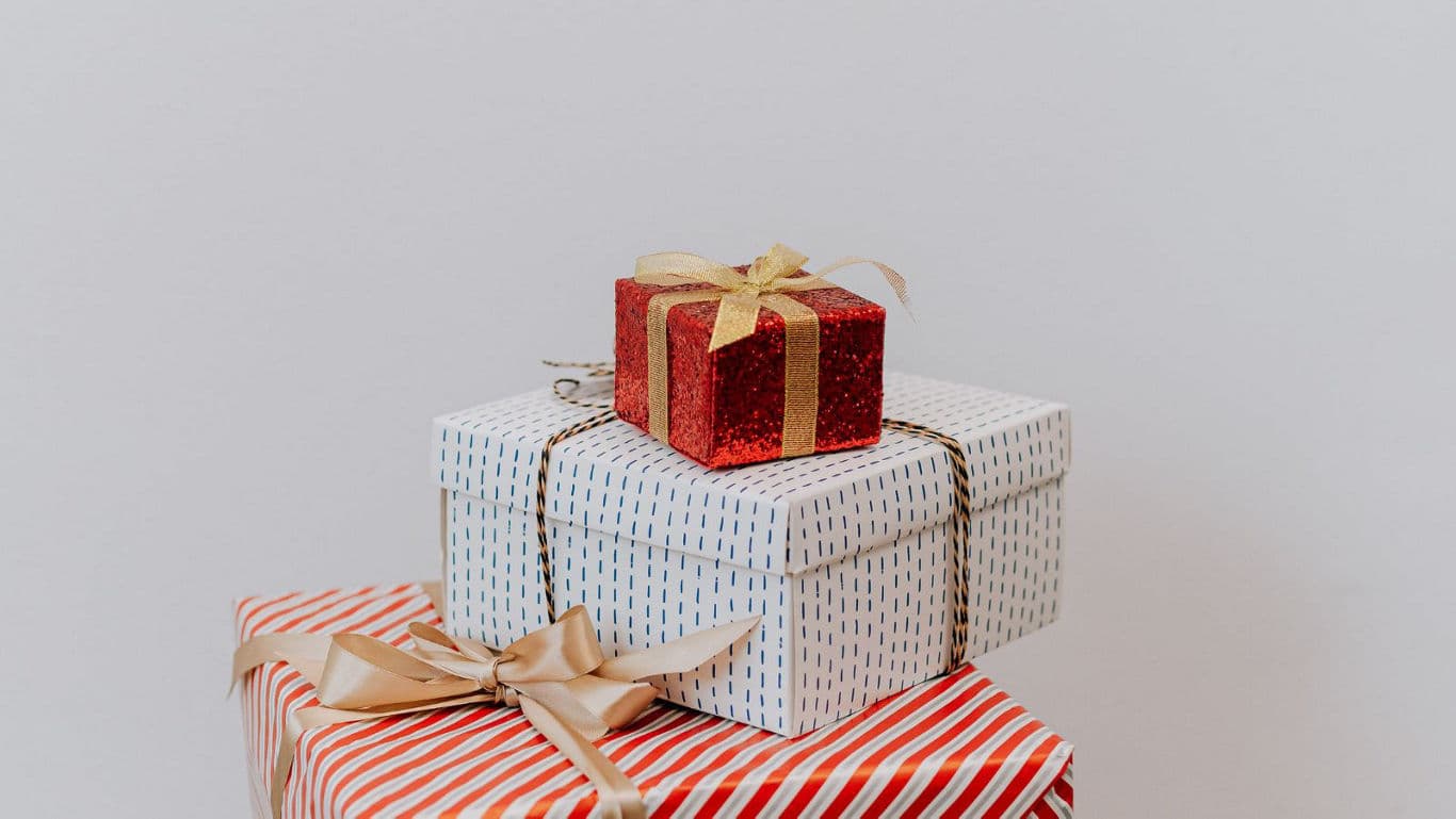 Stacked festive gift boxes with ribbons
