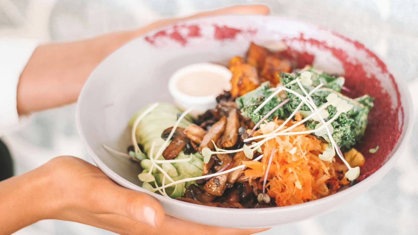 Colorful vegetable bowl with fresh greens and sauce