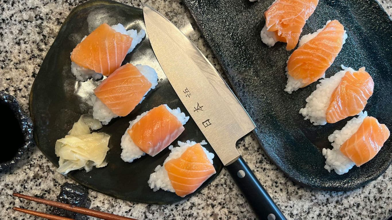 Salmon nigiri sushi with Japanese chef knife