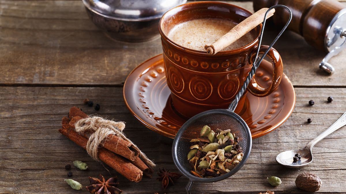 Masala chai with spices around it