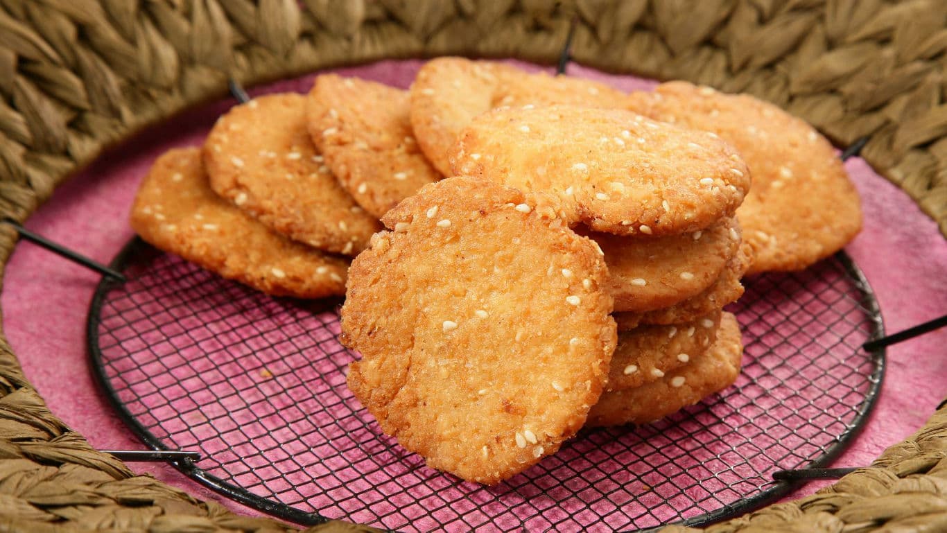 Stack of sesame cookies on cooling rack