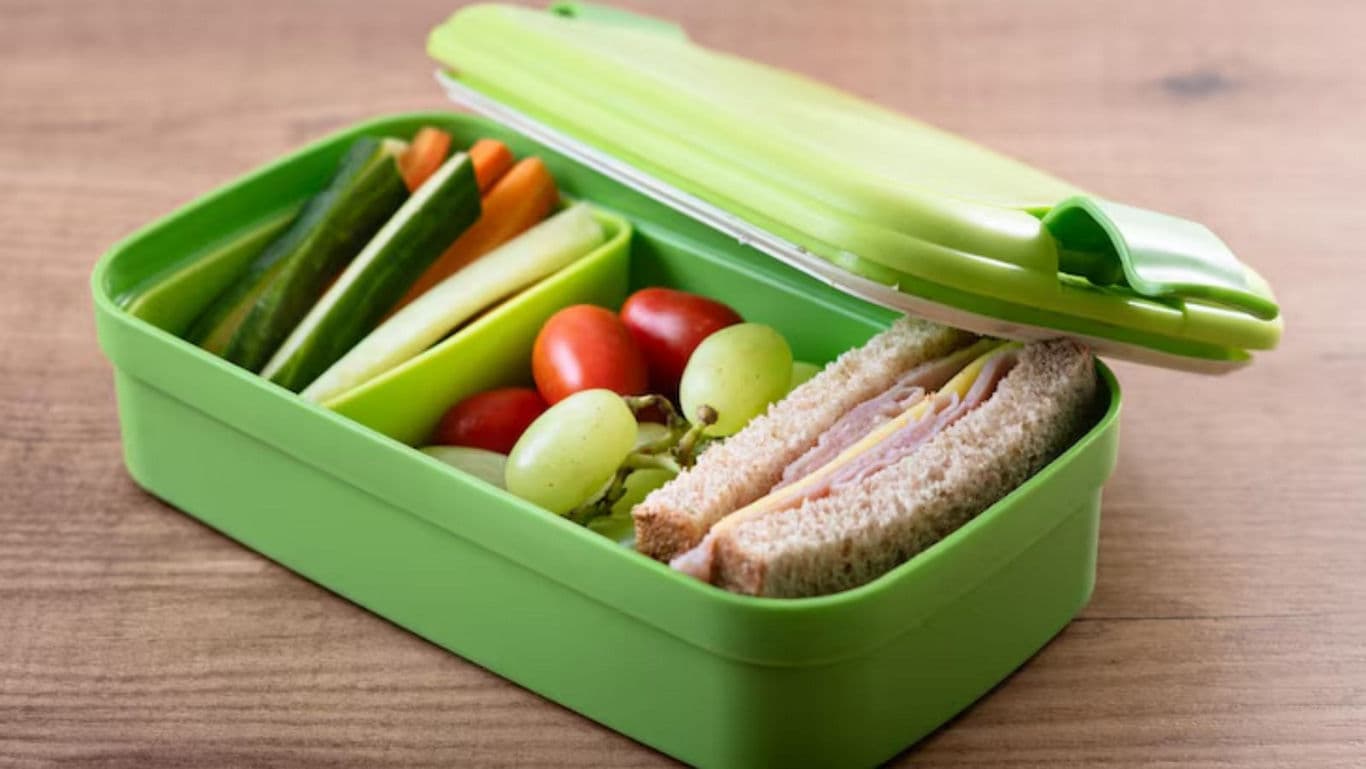Healthy lunchbox with sandwich and vegetables
