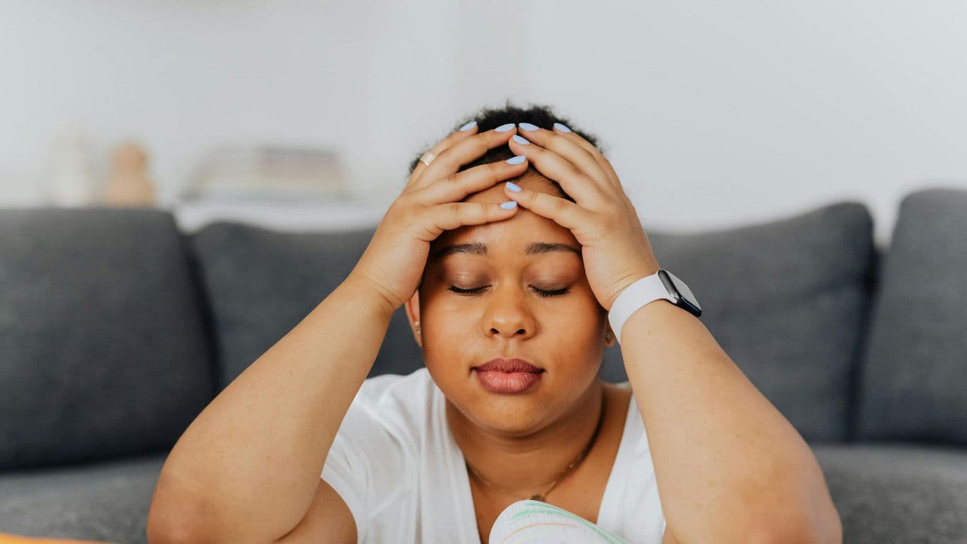 Tired woman resting with hands on head