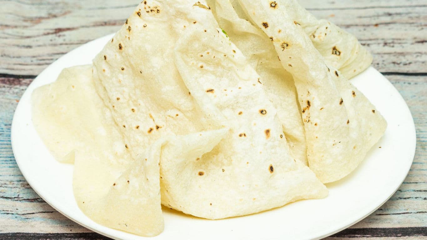 Stack of thin flatbreads on plate