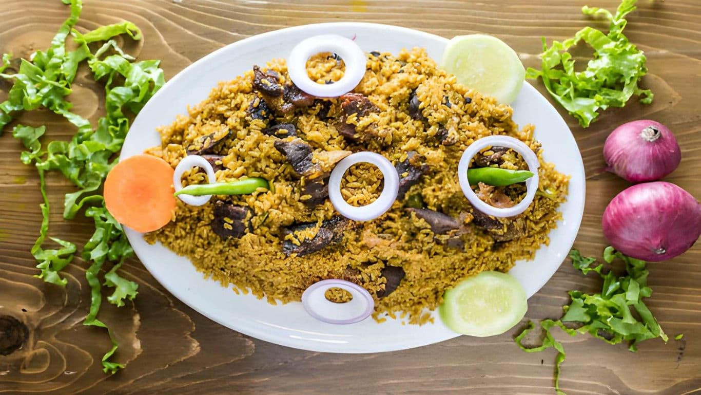 Spiced rice with meat and vegetables on platter