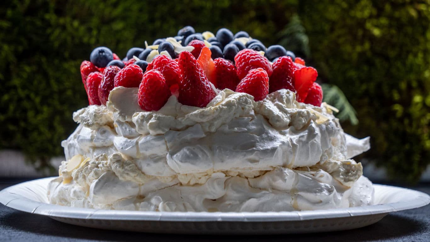 Berry topped pavlova dessert on plate