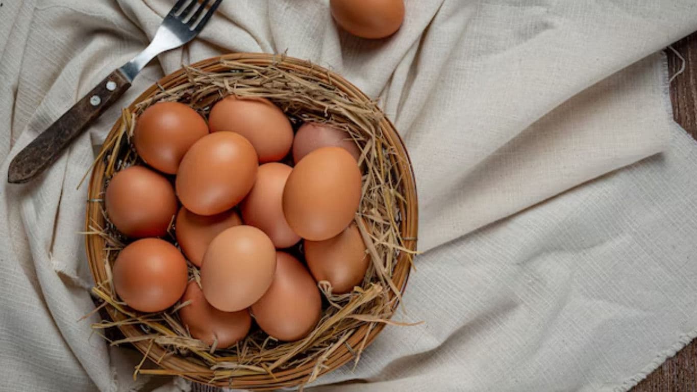Fresh brown eggs in a rustic straw basket