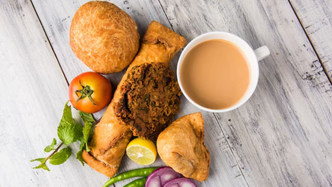Indian Tea with Samosa, Bun, and Fresh Vegetables