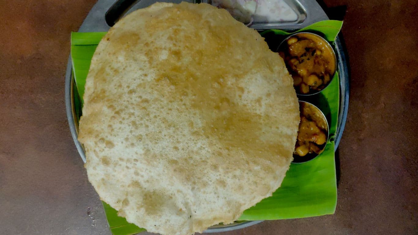 Indian puri meal served on banana leaf
