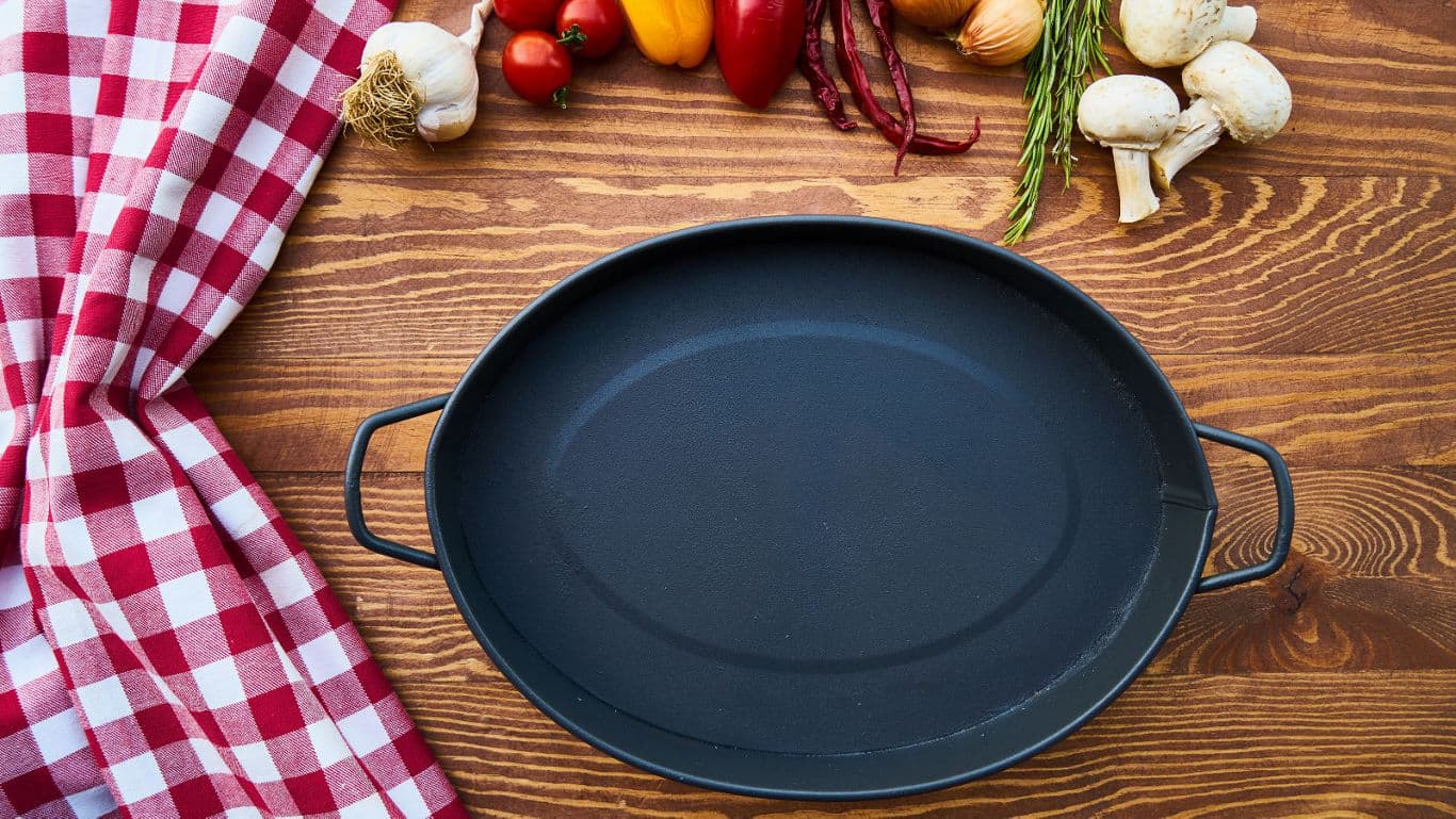 Empty cast iron pan with fresh vegetables