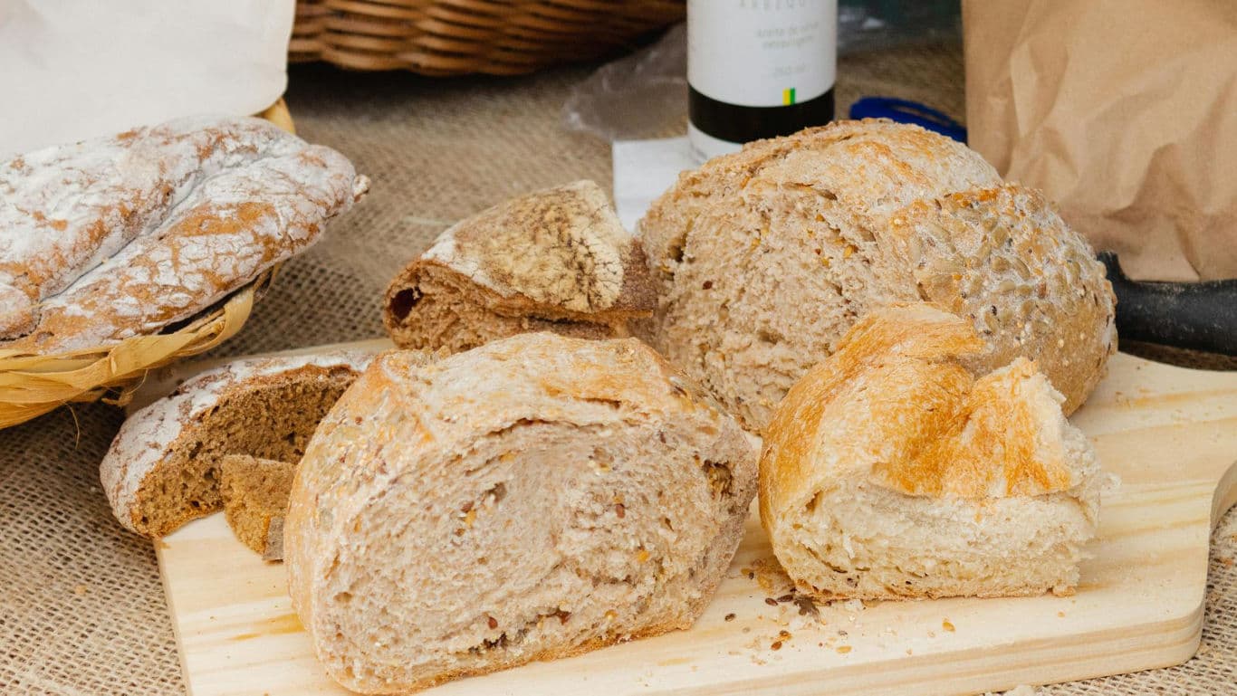 Rustic sliced bread loaves on board