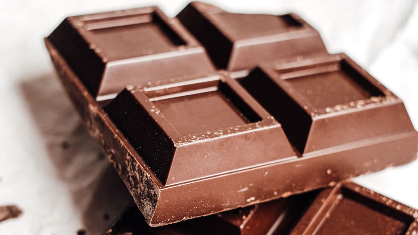 Close-up of stacked dark chocolate bars