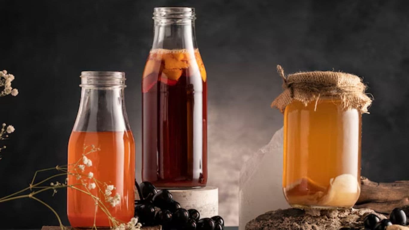 Assorted Homemade Juices in Glass Bottles on Rustic Table