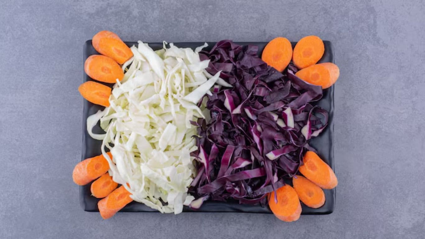 Shredded cabbage and carrots on platter