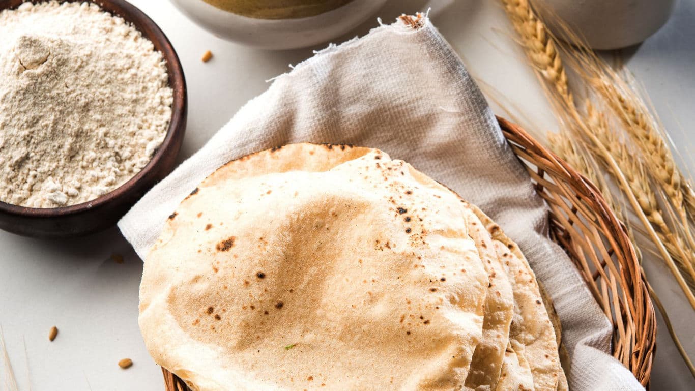 Freshly baked flatbreads with flour and wheat stalks