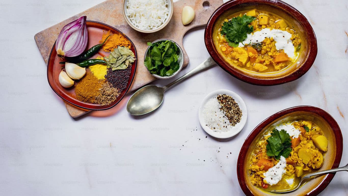 Indian curry with spices, rice, and fresh herbs