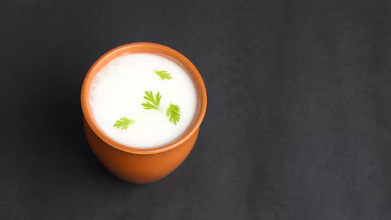 Traditional clay cup of buttermilk with herbs