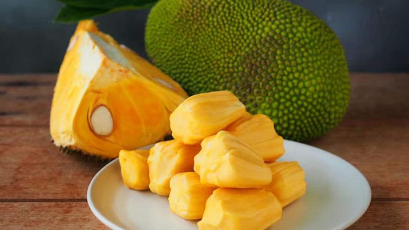 Fresh Jackfruit Segments on White Plate Indoors